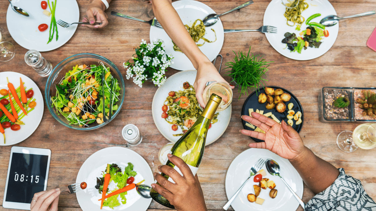 Wine glasses paired with vegetarian and vegan dishes at a dinner table
