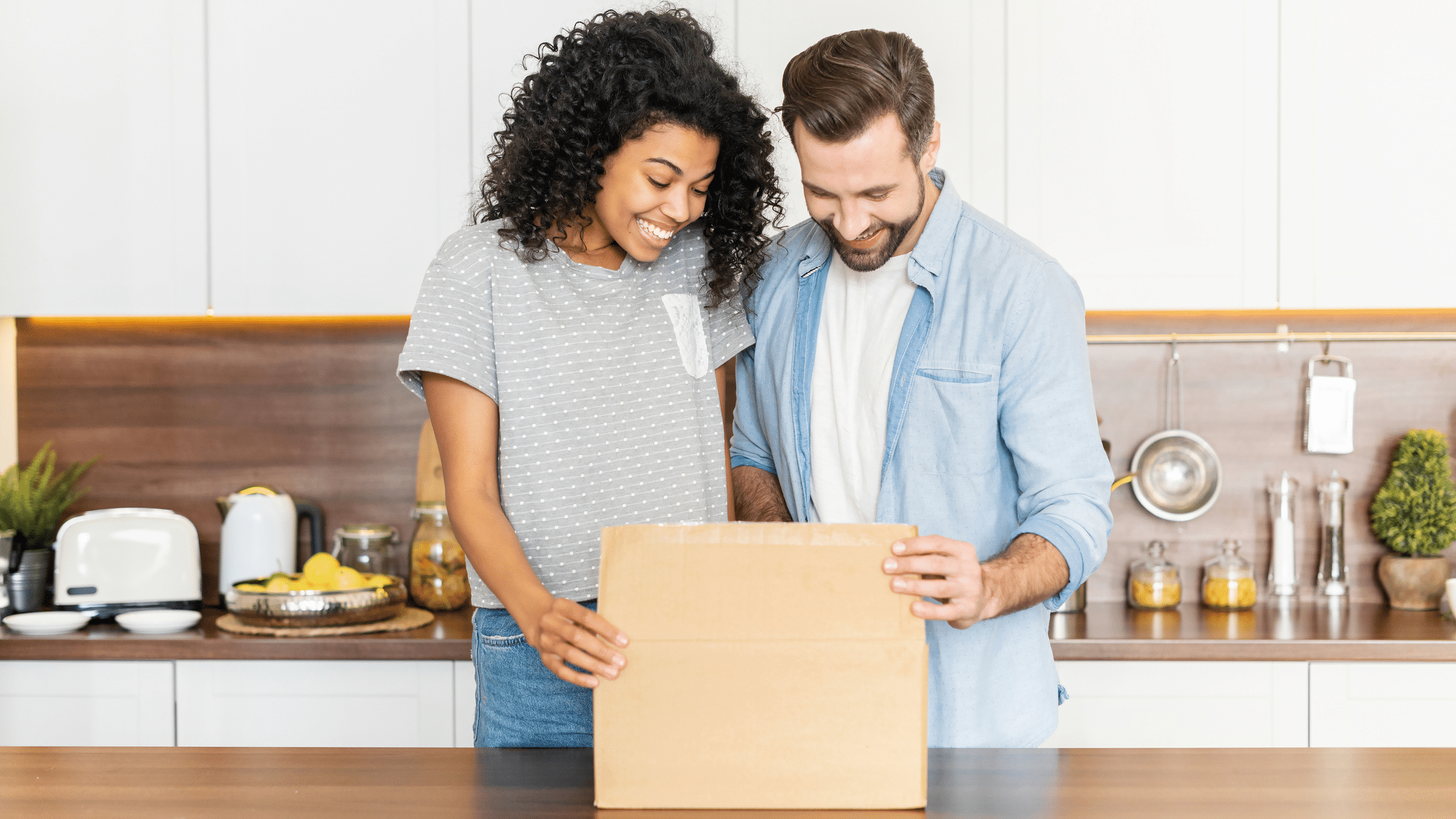 Couple opening wine club membership box